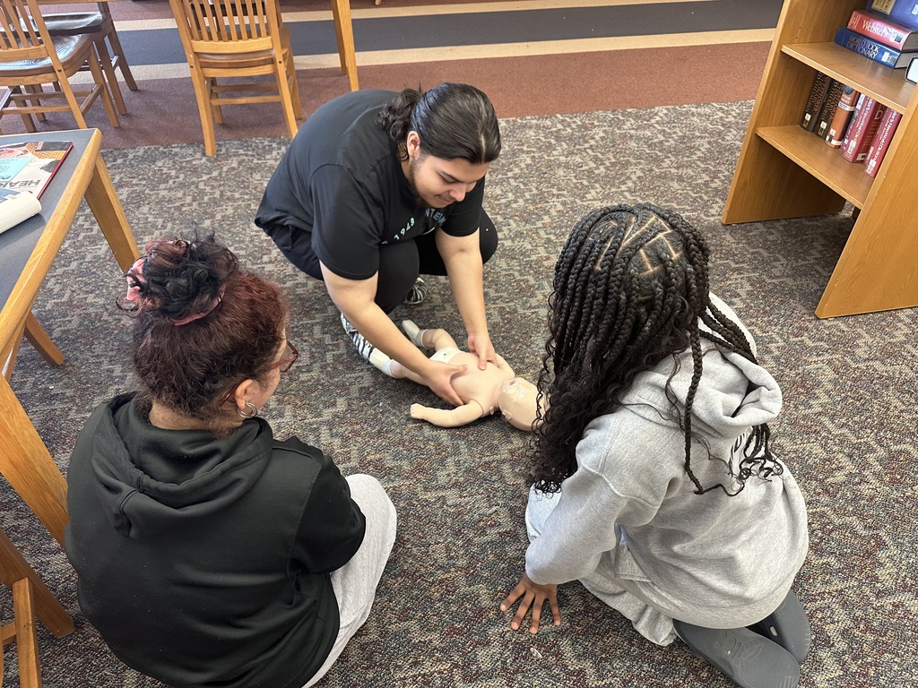 Students performing CPR on a dummy