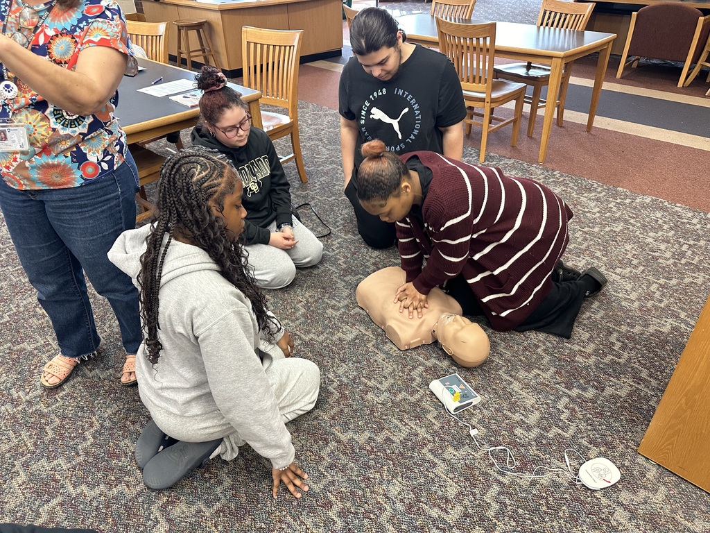 Students performing CPR on a dummy
