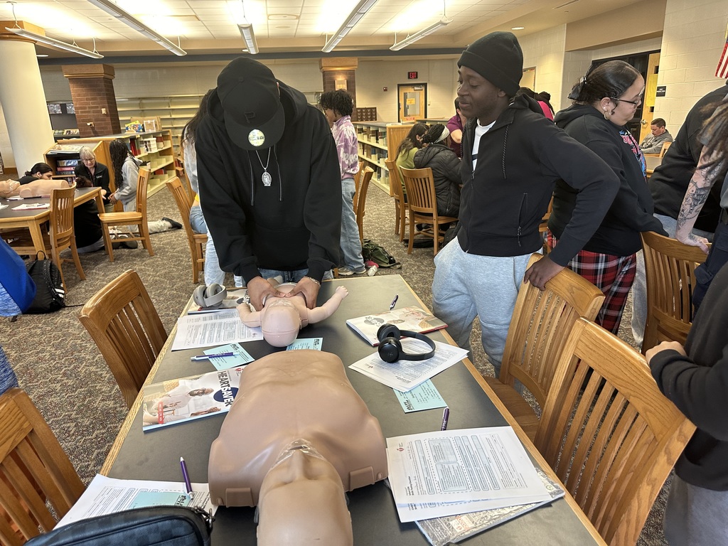Students performing CPR on a dummy