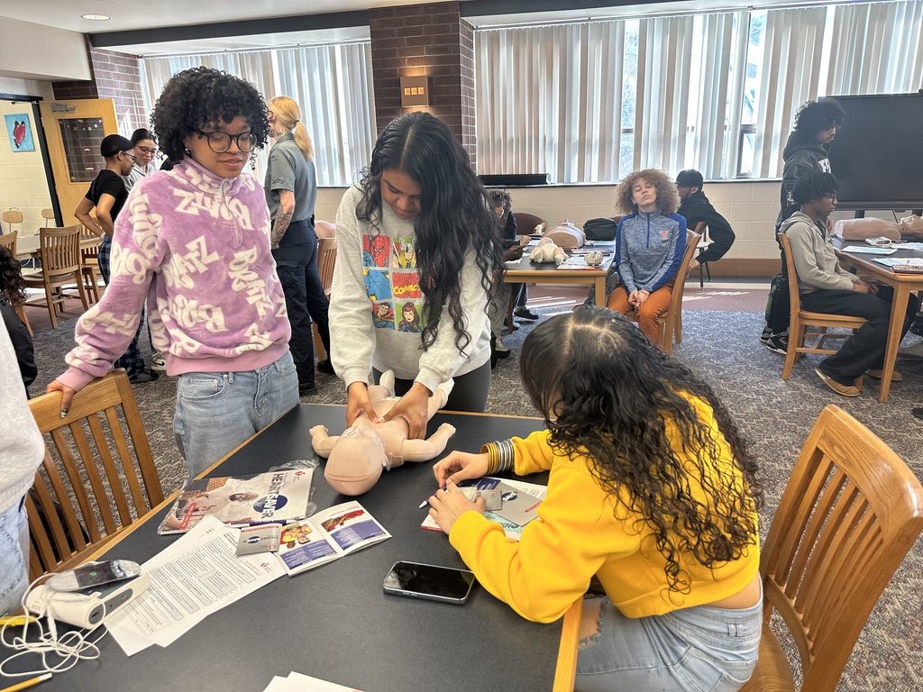 Students performing CPR on a dummy