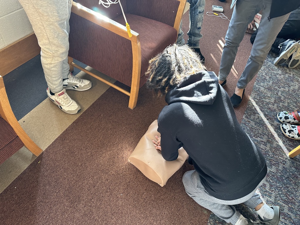 Students performing CPR on a dummy
