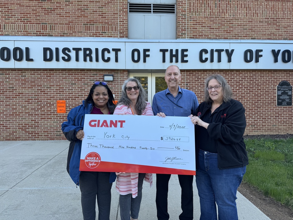 GIANT Donation - Group of people holding up a check