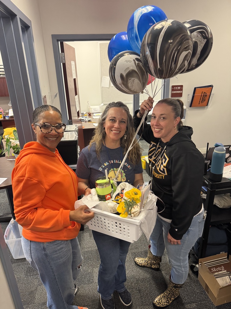 Jackson Principal and Assistant Principal recognizing a staff member at Jackson