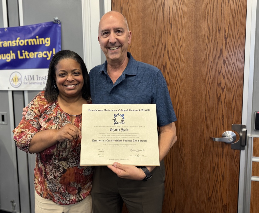 Superintendent Dr. Berry-Brown and Business Manager, Shawn Hain holding up a certificate.