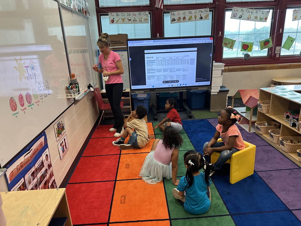 A teacher teaching a group of students in a classroom.