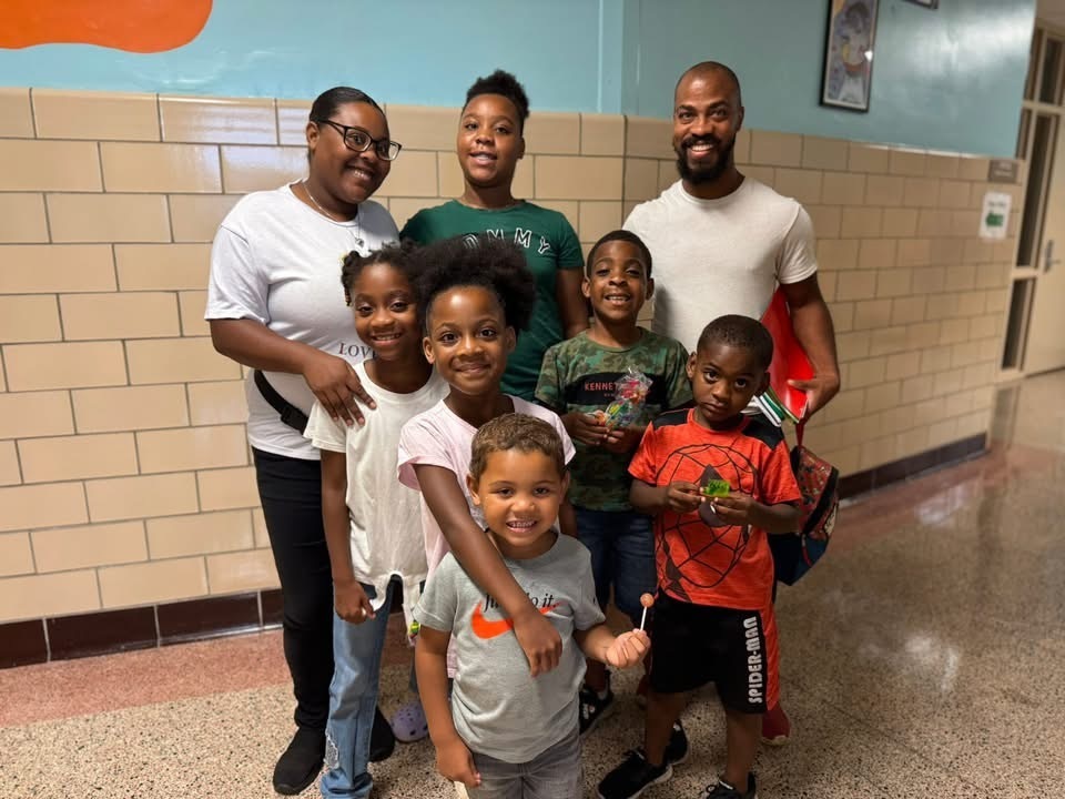 Two adults and six children at Devers PreK-8's Back to School Night.