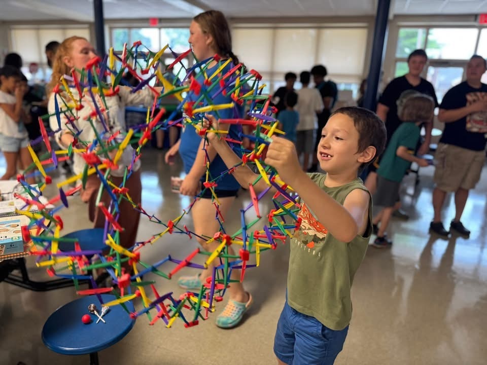 Student playing with a stretchy ball at Devers PreK-8's Back to School Night.