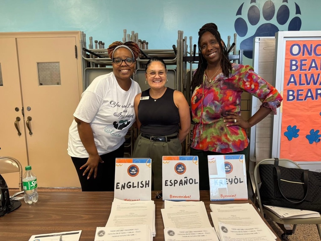 District parent liaisons Sandie Walker and Madeline Torres Ocasio with a district staff member at Devers PreK-8's Back to School Night.