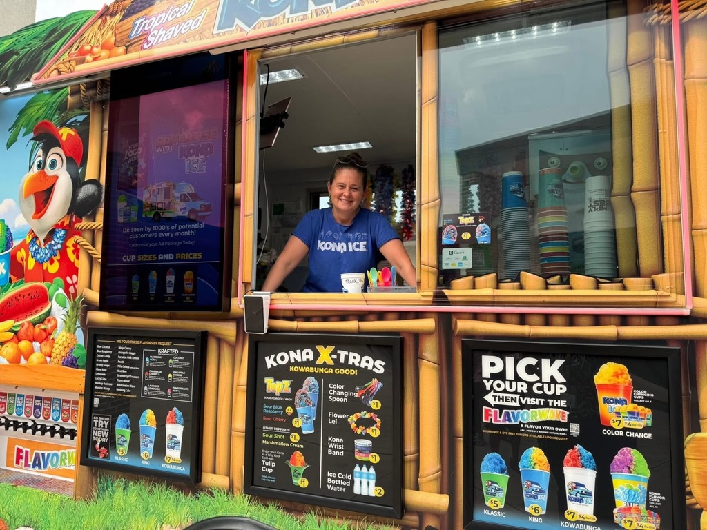 An adult standing in a Kona Ice Truck at Goode PreK-8's Back to School Night. 