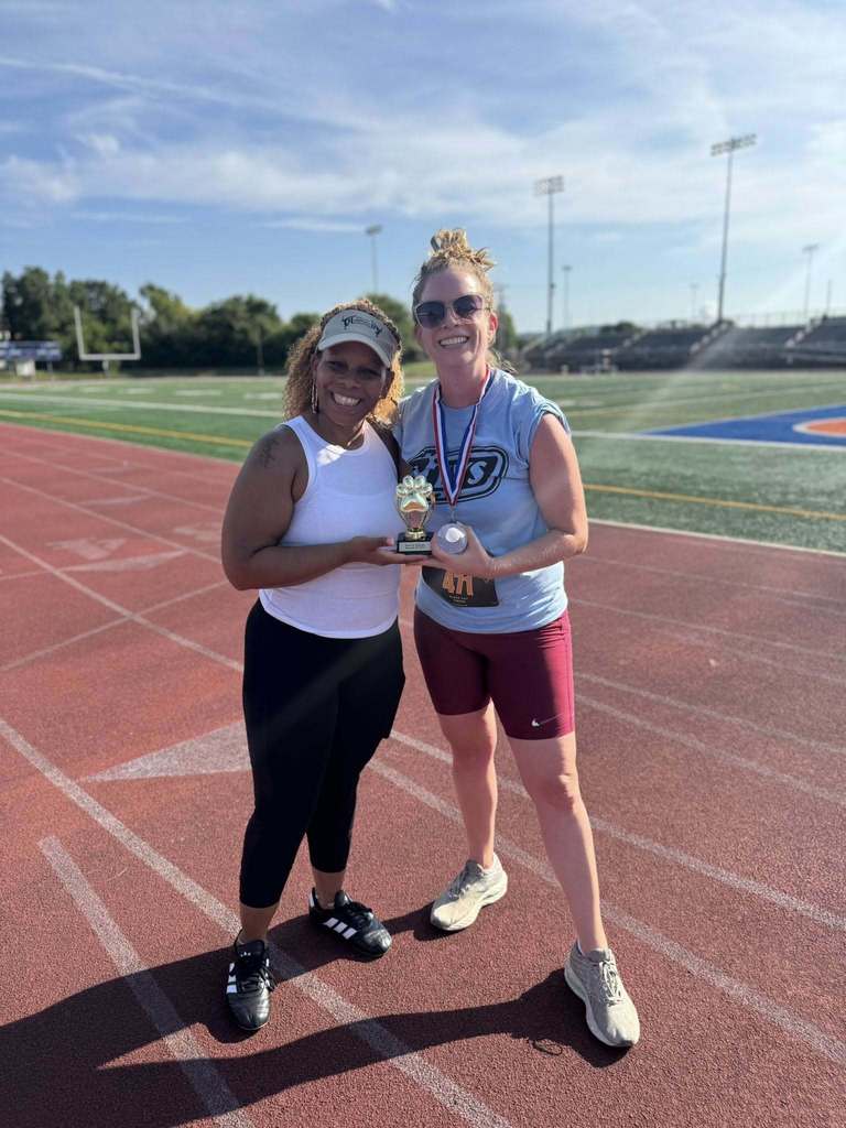 District staff members holding up a trophy at the School District of the City of York's 5K Run and Walk.
