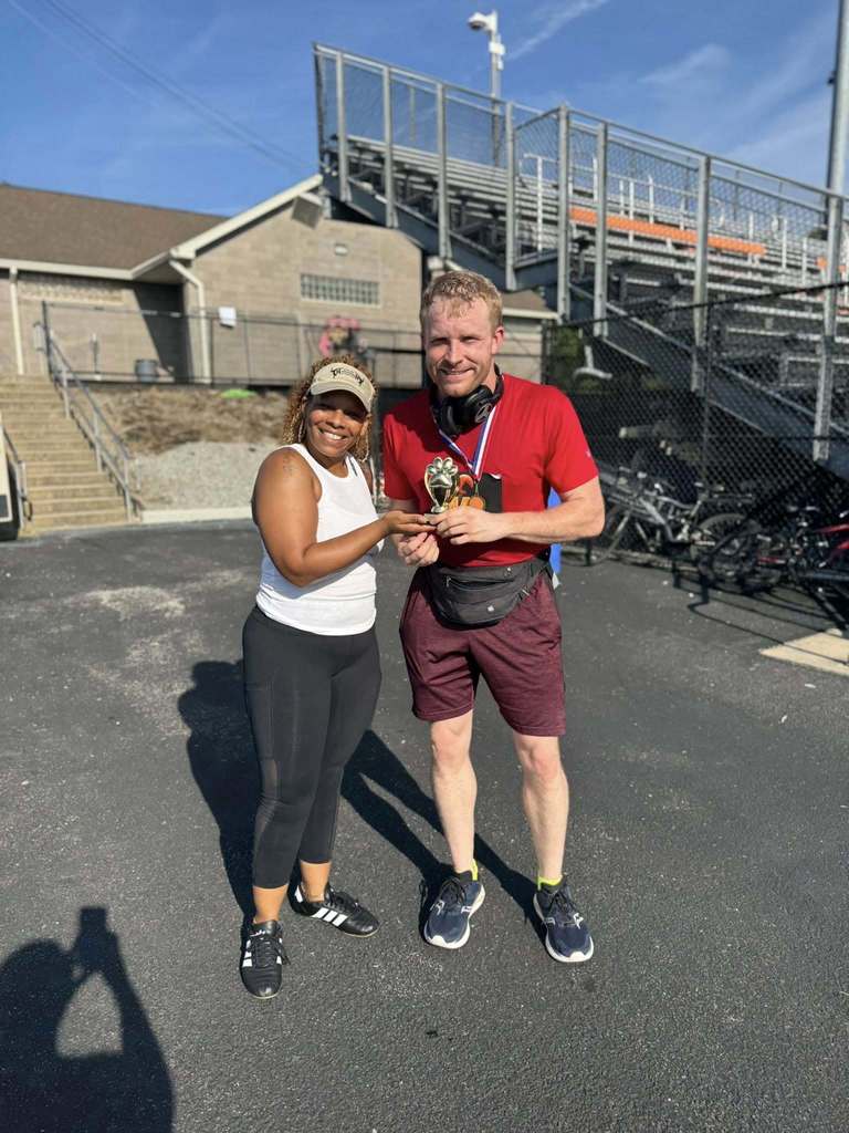District staff members holding up a trophy at the School District of the City of York's 5K Run and Walk.