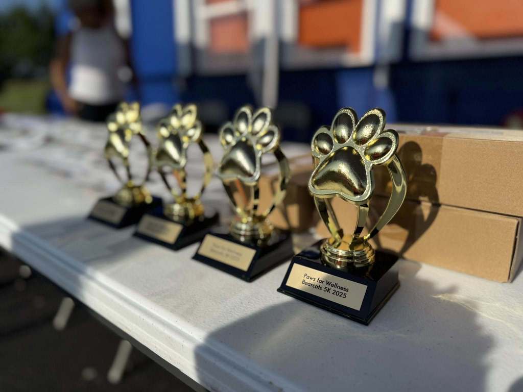 Trophies that say "Paws for Wellness Bearcats 5K 2025".