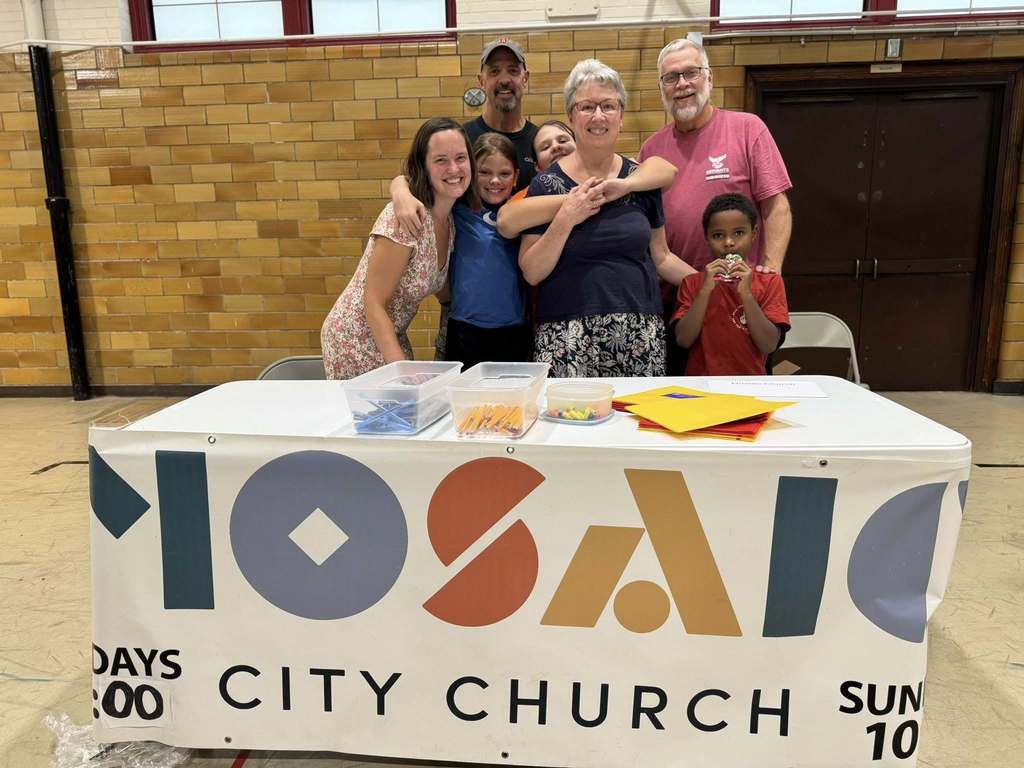 Four adults and three children posing together at Davis PreK-8's Back to School Night.