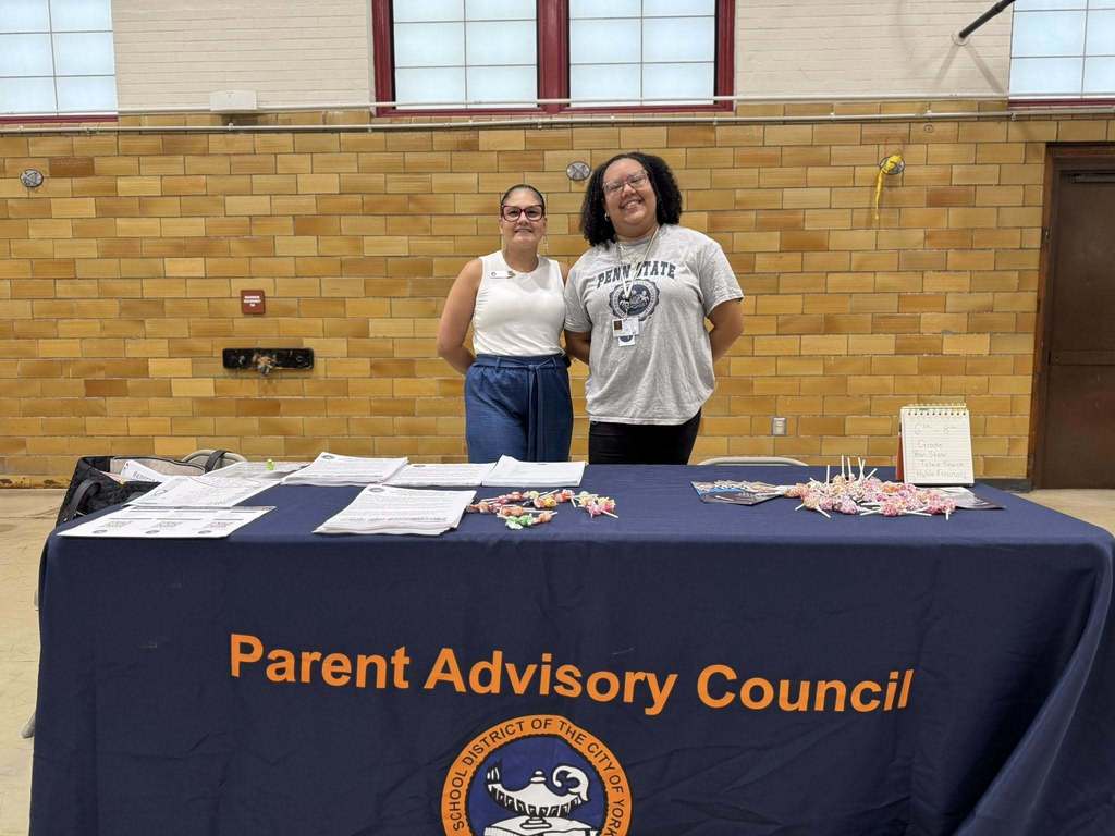 District parent liaison posing with a district staff member at Davis PreK-8's Back to School Night.