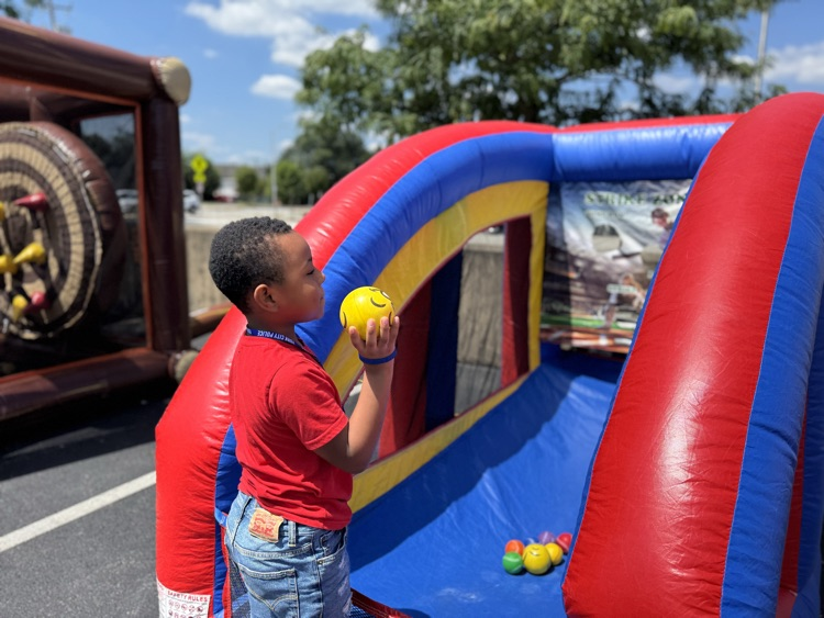 A child holding a ball in his hand.