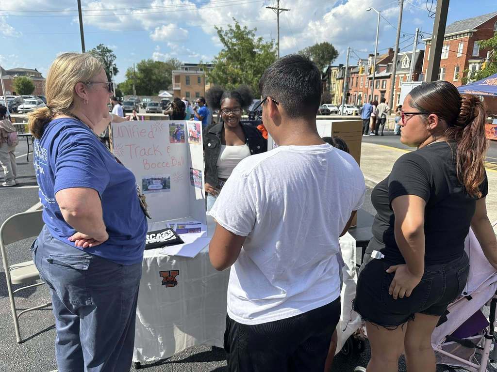 People visiting a community partner table