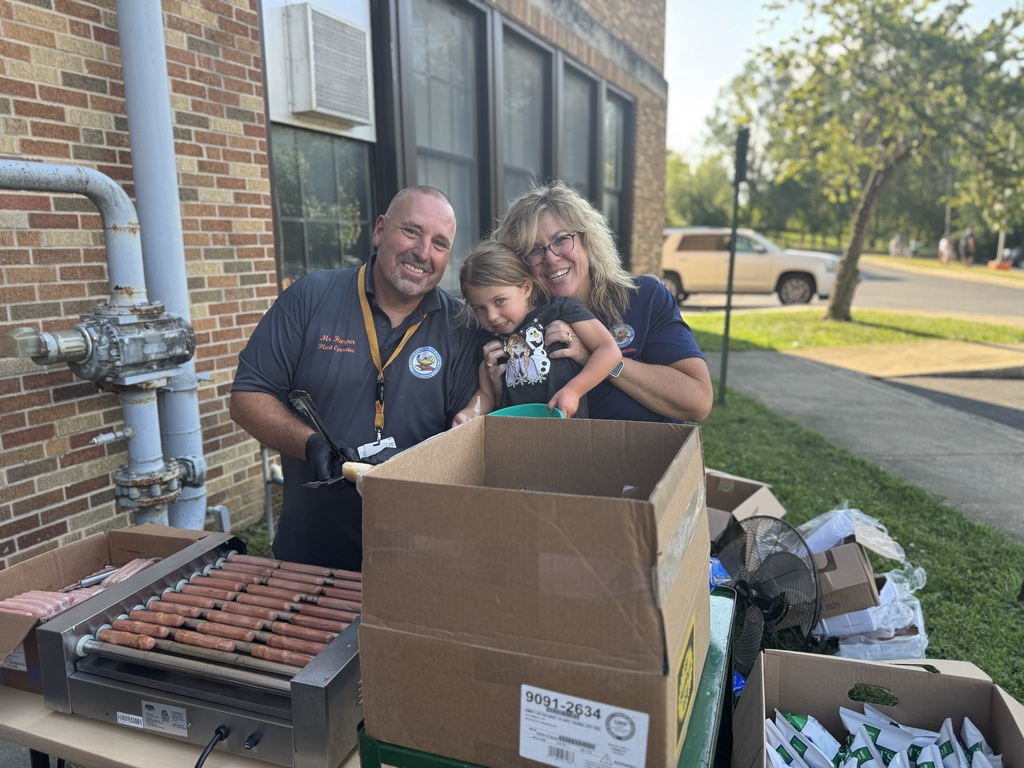 Two district staff members and a student posing for a photo. 