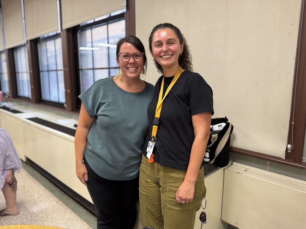 Two district staff members posing for a photo.
