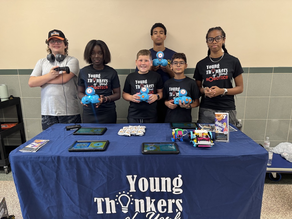 A group of young people from Young Thinkers of York  holding up a device.