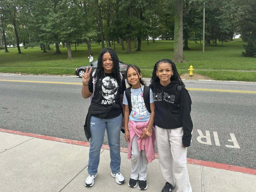 Three students at Ferguson PreK-8 posing for a photo. One student is holding up the peace sign.