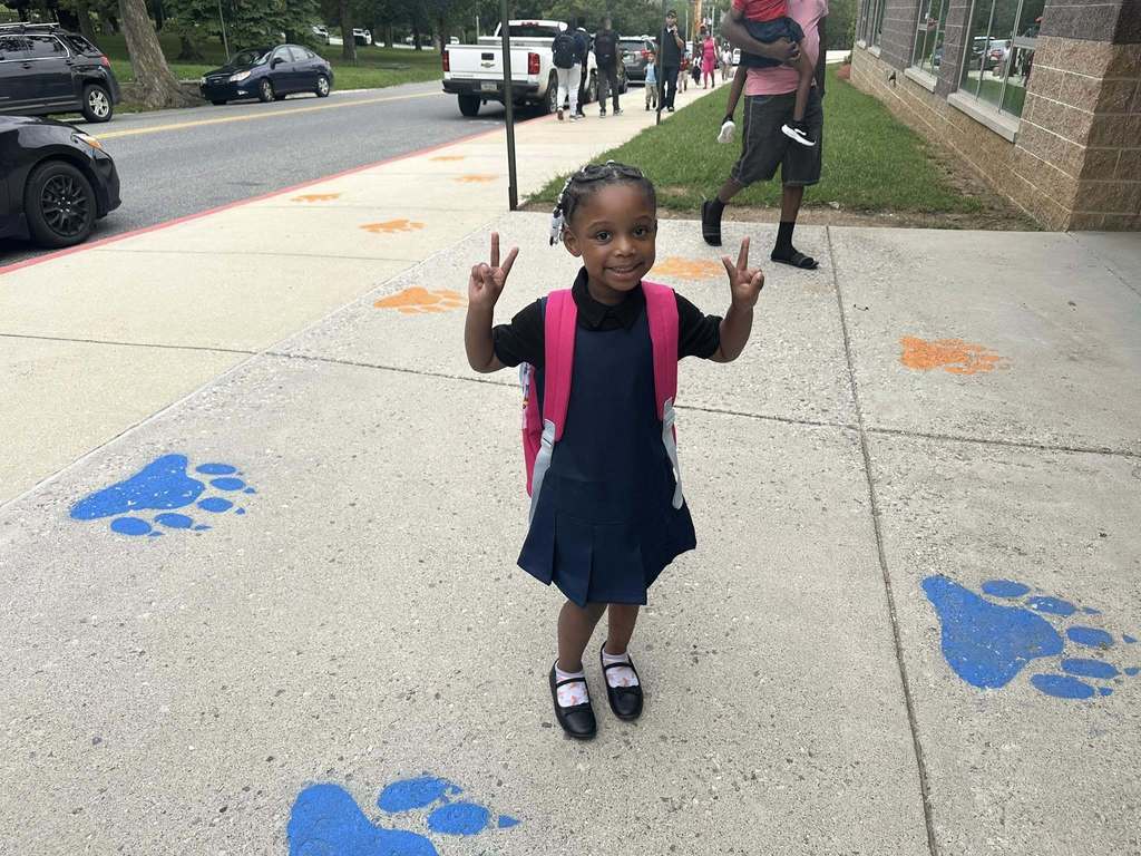 A student at Ferguson PreK-8 holding up two peace signs.