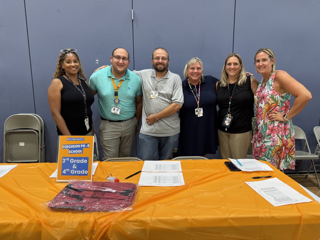 Six district staff members posing for a photo during Ferguson PreK-8's Back to School Night.