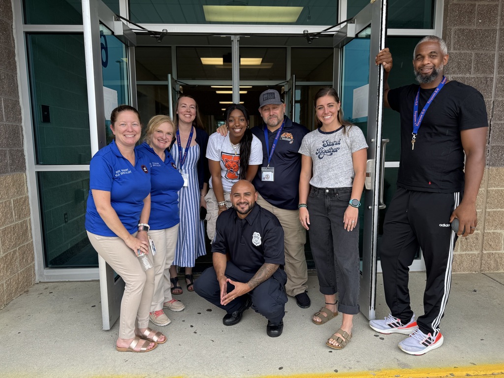 A group of district staff members standing in a doorway during Ferguson PreK-8's Back to School Night.