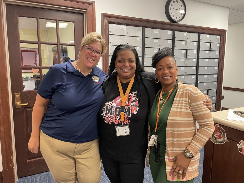 Dr. Andrea Berry-Brown, Superintendent of Schools standing in between Smith STEAM Academy Principal, Ms. Myers and Smith STEAM Academy Assistant Principal, Mrs. Merisca in an office.
