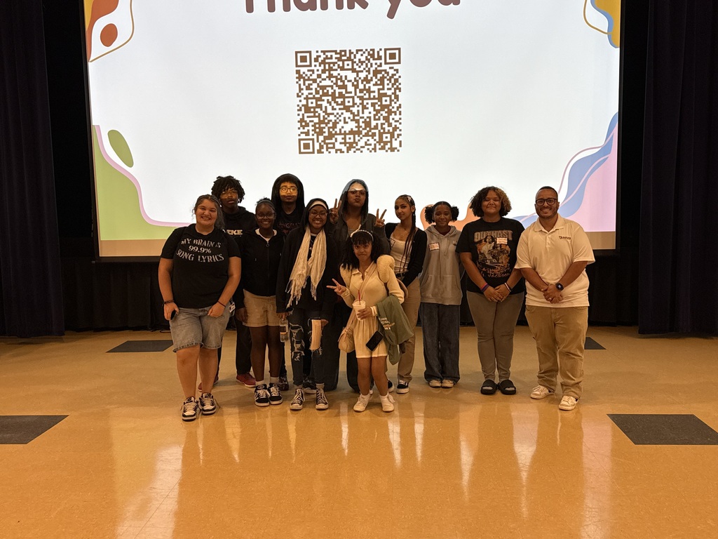 Group of William Penn Senior High School students and an adult standing in front of a projector screen that says "Thank you" with a QR code beneath it.
