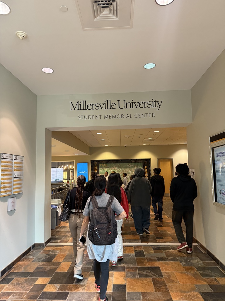 A group of William Penn Senior High School students walking down a hallway at Millersville University.
