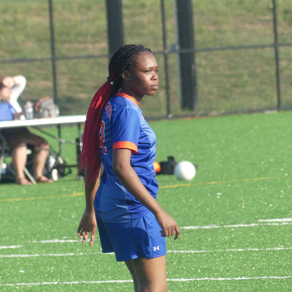 York High Girls Soccer player walking outside on the field.