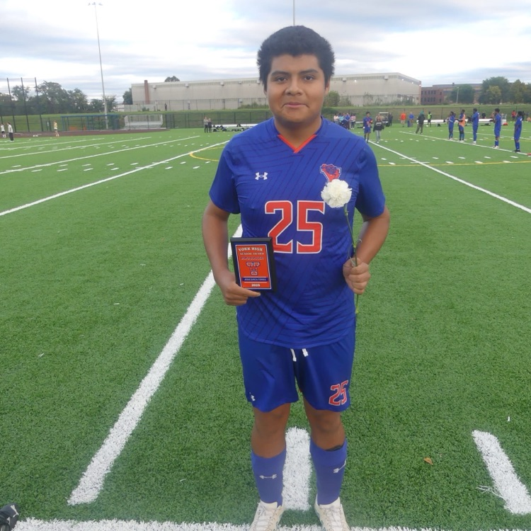 A York High Boys Soccer team player standing