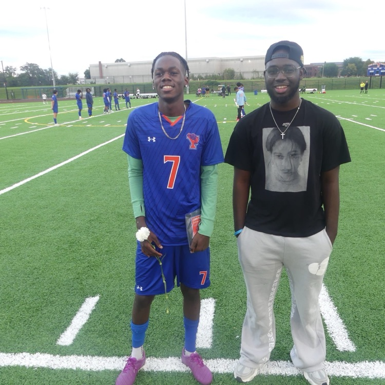 A York High Boys Soccer team player and a man standing