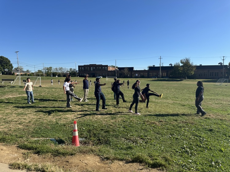 A group of students participating in an exercise training outside.