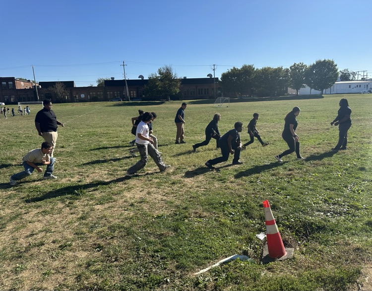 A group of students participating in an exercise training outside.