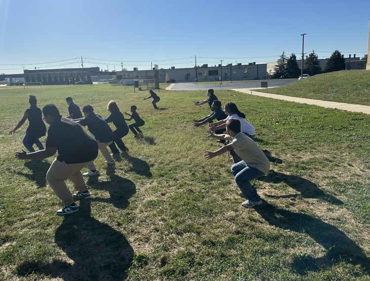 A group of students participating in an exercise training outside.