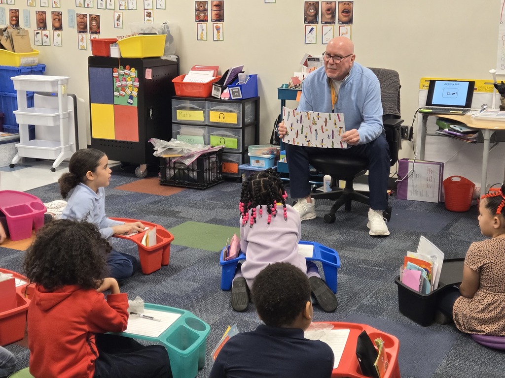 Mr. Rob Bernhard reading to a group of students