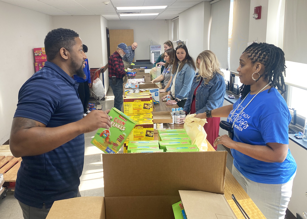 Social workers volunteering and packing a bag