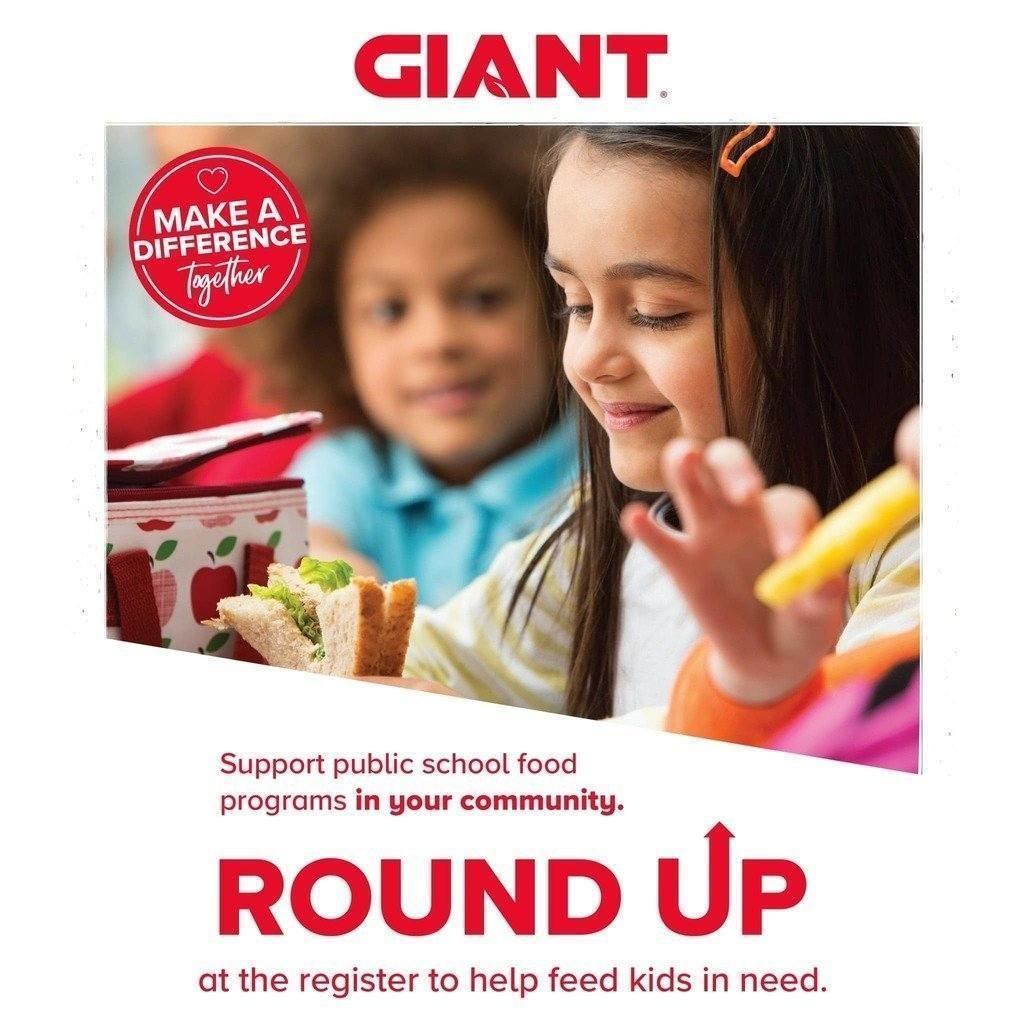 Two smiling children are enjoying school lunches. Text reads: "GIANT. Make a Difference Together, Support public school food programs in your community. Round Up at the register to help feed kids in need."