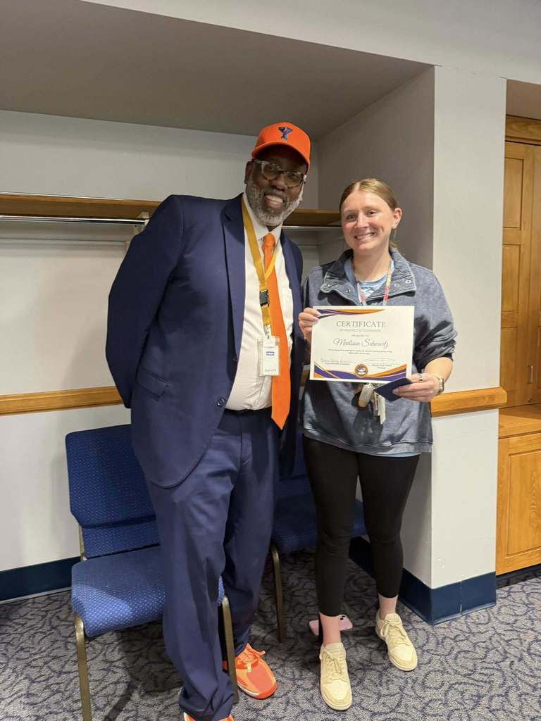 Dr. George Fitch, Supervisor of Student Services, Dr. Andrea Berry-Brown, Superintendent of Schools, is standing next to a district staff member who is holding a Perfect Attendance certificate for the second marking period.