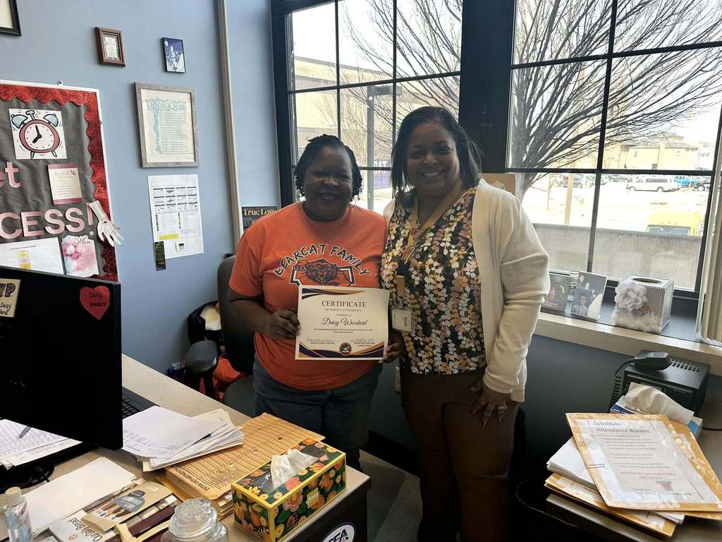 Dr. Andrea Berry-Brown, Superintendent of Schools, is standing next to a district staff member who is holding a Perfect Attendance certificate for the second marking period.