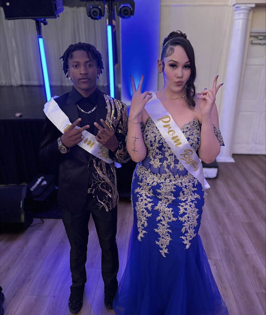 Two William Penn Senior High School students are posing for a photo together while wearing Prom Royalty sashes.