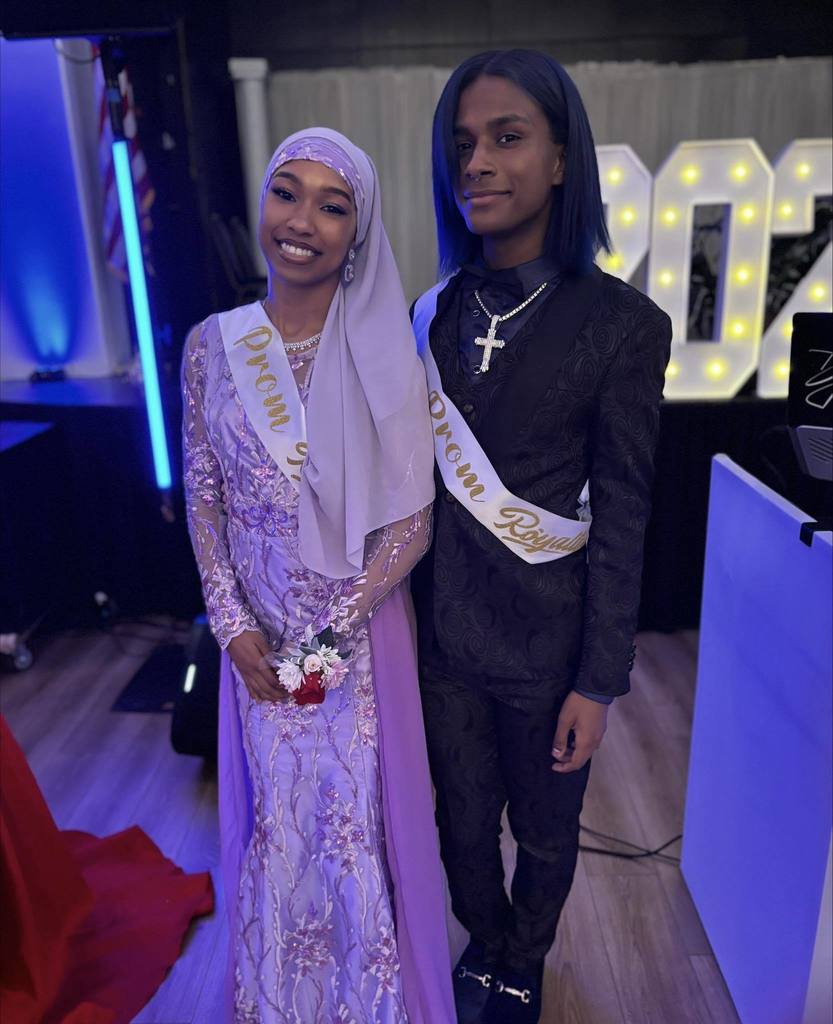 Two William Penn Senior High School students are posing for a photo together while wearing Prom Royalty sashes.