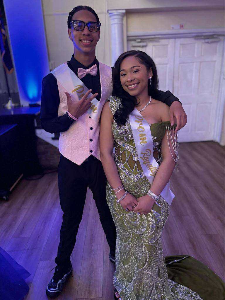 Two William Penn Senior High School students are posing for a photo together while wearing Prom Royalty sashes.
