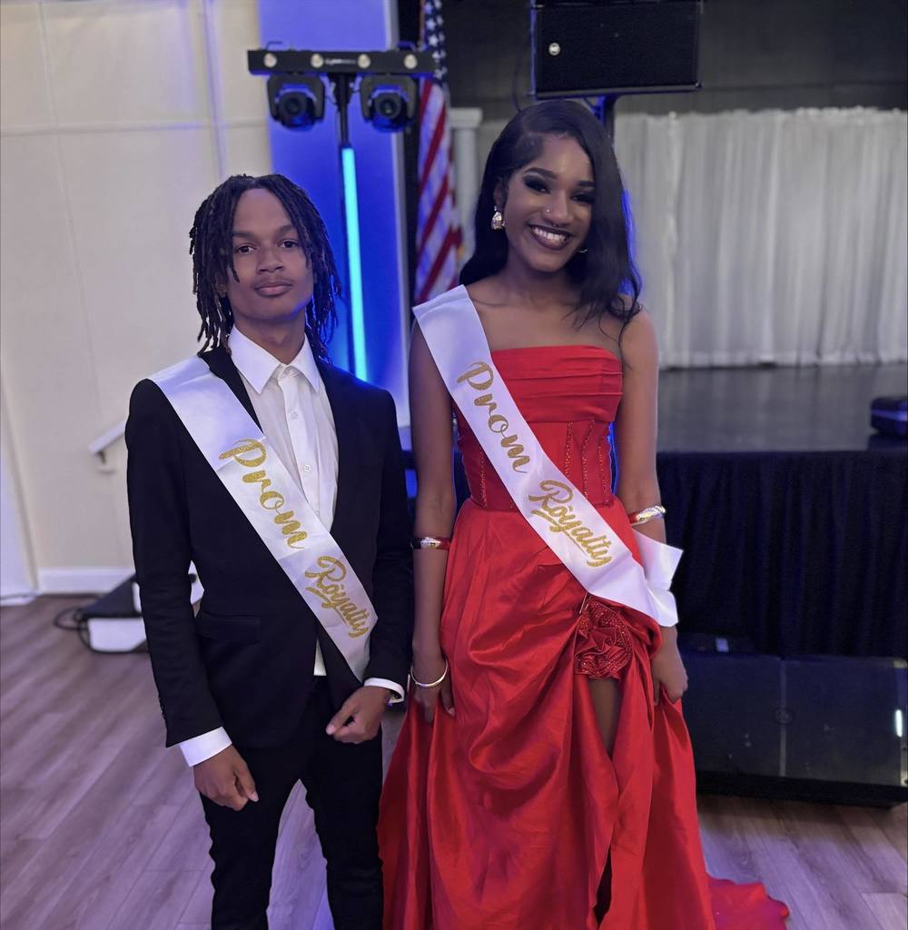 Two William Penn Senior High School students are posing for a photo together while wearing Prom Royalty sashes.