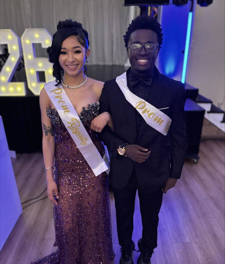Two William Penn Senior High School students are posing for a photo together while wearing Prom Royalty sashes.