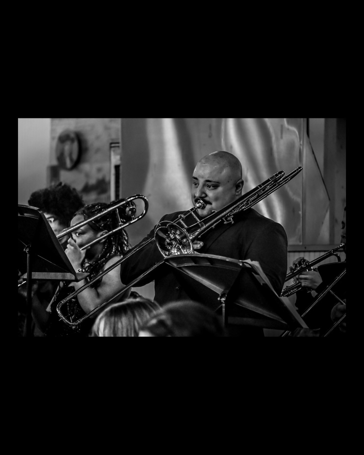 WPSHS performing in central market, Director playing the trombone 