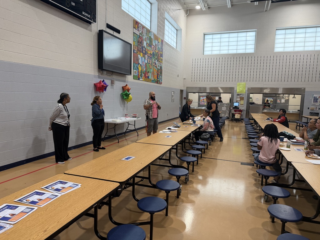Ferguson families recently attended a literacy meeting in a school cafeteria.