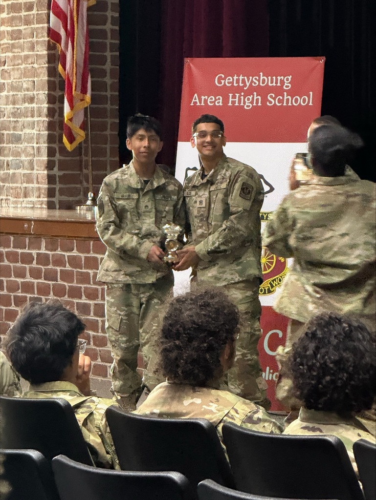 Two William Penn JROTC cadets are posing with a trophy at a Raider Challenge competition at Gettysburg Area High School.