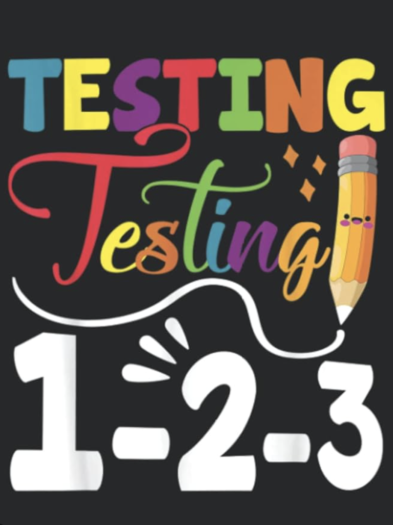 A poster with colorful letters spelling out "Testing Testing 1-2-3" and an image of a pencil.